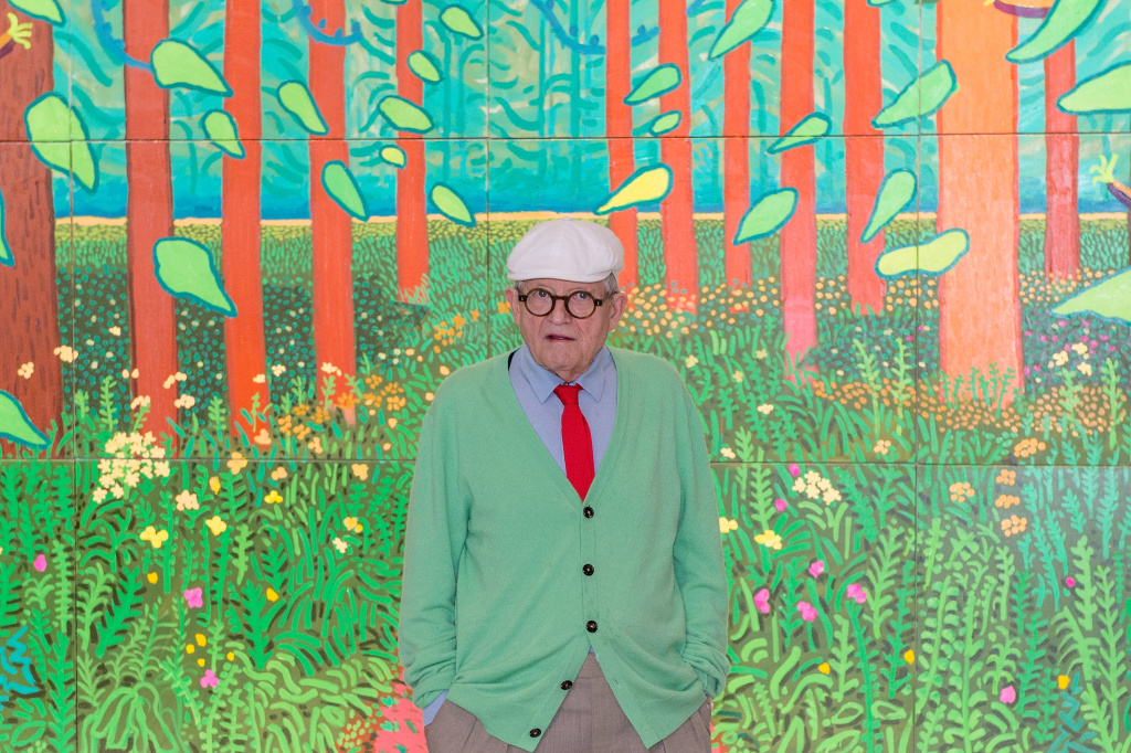 Artist David Hockney Unveils 'The Arrival of Spring' At Centre Georges Pompidou In Paris David Hockney poses in front of his painting