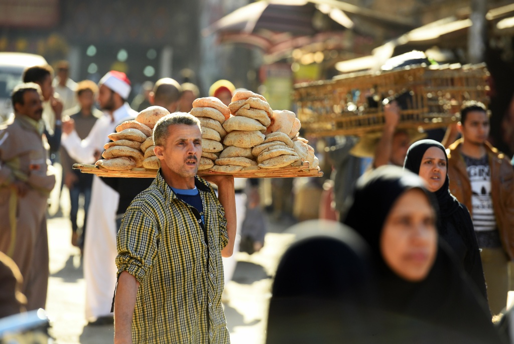 EGYPT-DAILY LIFE An Egyptian man sells bread outside the al-Azhar mosque in Cairo on December 8, 2017.