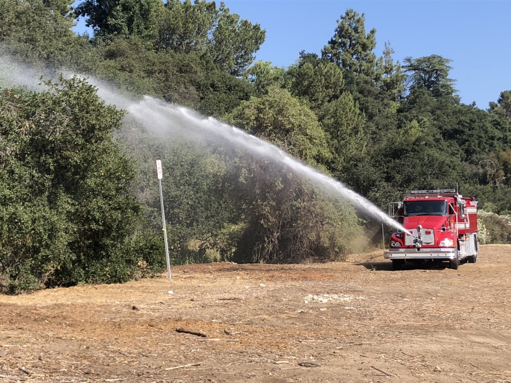 Firefighters spray fire retardant on brush near Rose Bowl to prepare for fireworks. Firefighters spray fire retardant on brush near Rose Bowl to prepare for fireworks.