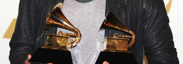 Usher poses with his awards during the 53nd annual Grammy Awards in Los Angeles, California on February 13, 2011.