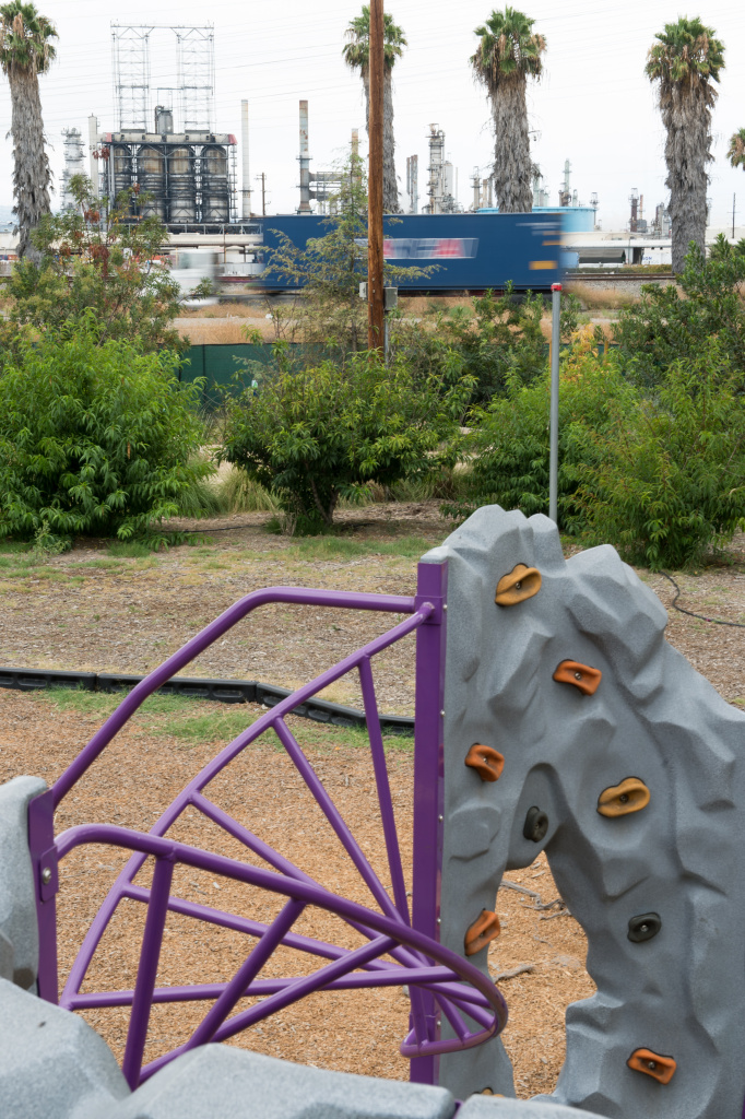 Air Pollution Playgrounds - INLINE An oil refinery and highway are visible over the fence of a Long Beach child care center. KPCC reporters Deepa Fernandes and Sarah Monte investigate the effect of air pollution on early childhood development by taking air quality readings outside of child care centers located in Los Angeles County.