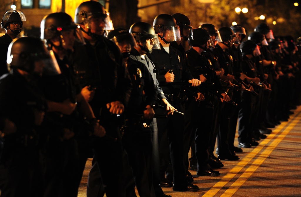 Police in riot-gear move in on anti-Wall Police in riot-gear move in on anti-Wall Street demonstrators as Occupy L.A. protesters take to the streets around City Hall in downtown Los Angeles, early on Nov. 28, 2011. More than 1,000 anti-Wall Street protesters defied a deadline to leave a park near Los Angeles City Hall Monday, as police vowed to evict them
