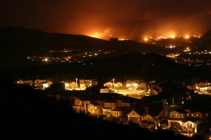 Wildfires burned in the hills of Santa Clarita, Calif., threatening suburban development in October 2007. This fire was among more than a dozen major wildfires, many of which were started from human-related ignitions. Wildfires burned in the hills of Santa Clarita, Calif., threatening suburban development in October 2007. This fire was among more than a dozen major wildfires, many of which were started from human-related ignitions.