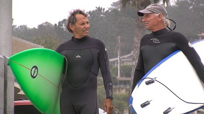 Vietnam veterans James Lischer, left, and Bobby Lux get ready to surf at Del Mar. Since the 1960's, surfing has helped them open up about their experience in Vietnam.