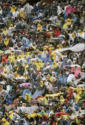 1938: People walk along the flooded L.A. River near the Dayton Avenue Bridge. In the background, a railroad bridge hangs in a twisted heap after one of the pilings has collapsed. (Photograph courtesy of the Los Angeles Public Library)