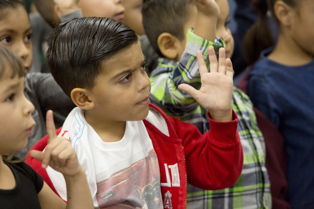 Dual Immersion mariachi - inline Noah Leake and his classmates make hand gestures while singing.