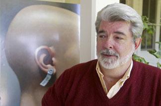 Filmmaker George Lucas, pictured at his Skywalker Ranch in Nicasio, Calif., Aug. 3, 2004, stands beside a poster of his first film, "THX 1138," which was just added to the National Film Registry.