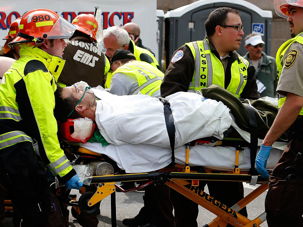 An injured man is loaded into an ambulance after two explosions during the 117th Boston Marathon near Copley Square on Monday. An injured man is loaded into an ambulance after two explosions during the 117th Boston Marathon near Copley Square on Monday.