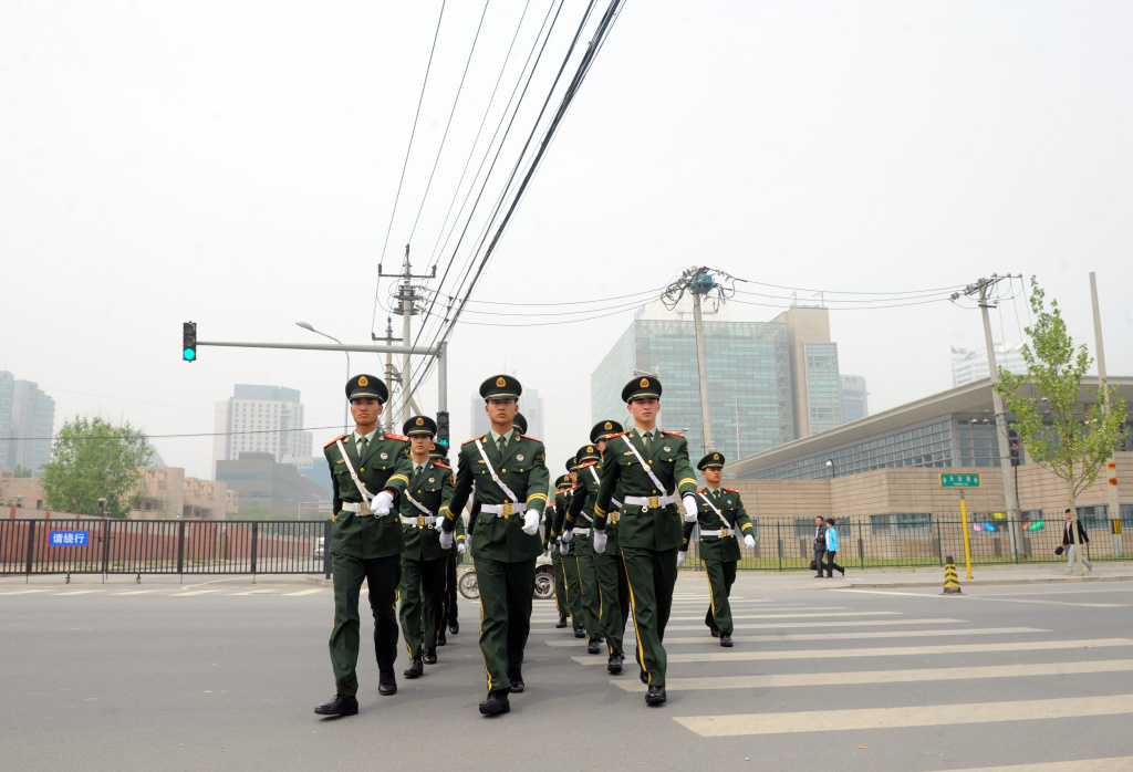 Chinese paramilitary guards march from t Chinese paramilitary guards march from the US embassy in Beijing on April 30, 2012. Chinese rights activist Chen Guangcheng is in the US embassy in Beijing but is not seeking asylum, fellow dissident Hu Jia said raising the spectre of a drawn-out China-US diplomatic standoff.