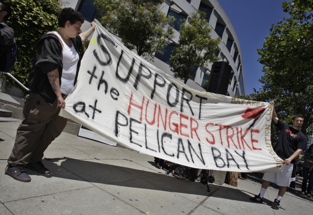 Prisoner Hunger Strike Demonstrators hold up a sign during a rally in front of the State Building in San Francisco, Friday, July 1, 2011 to support prisoners at Pelican Bay State Prison. Inmates in an isolation unit at Pelican Bay State Prison are on a hunger strike to protest conditions that they describe as inhumane. Advocates say several dozen inmates in the Security Housing Unit declined to eat their morning meal on Friday. The unit holds about a third of the 3,100 inmates at the Northern California prison. (AP Photo/Paul Sakuma)