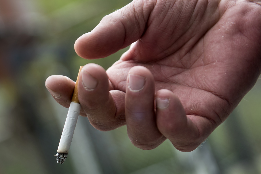 US-HEALTH-DRUGS-WESTVIRGINIA A recovering addict smokes at Recovery Point on April 19, 2017 in Huntington, West Virginia.
Huntington, in the northwest corner of West Virginia near Kentucky, has been portrayed as the epicenter of the opioid crisis.