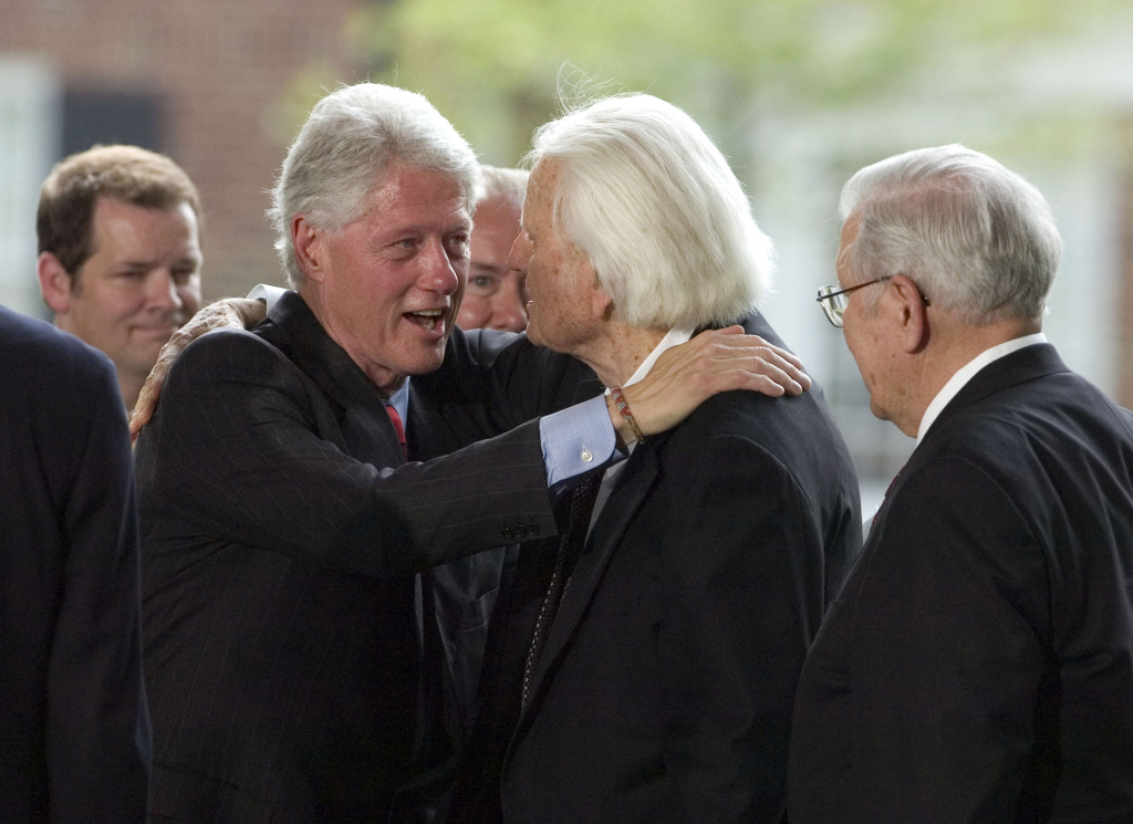 Former Presidents Bush And Clinton And Carter Attend Opening Of Billy Graham Library Evangelist Billy Graham (C) is greeted by former U.S. President Bill Clinton (L) on the stage during the Billy Graham Library Dedication Service on May 31, 2007 in Charlotte, North Carolina.