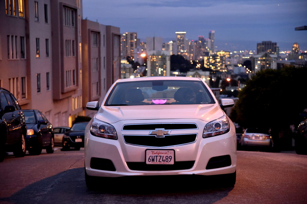 Lyft At Its San Francisco Headquarters Showcasing Lyft Cars, The Glowstache, The Lyft App, Lyft Passengers And Drivers A Lyft driver is waiting for a ride in the city on February 3, 2016 in San Francisco, California.