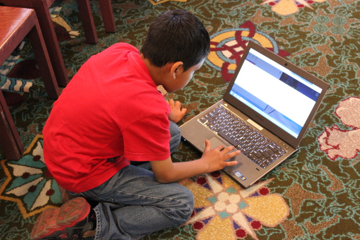 Children’s librarian Brooke Sheets (center) uses colored cups to teach algorithms and debugging to a group of girls at a computer science fair at L.A.'s downtown Central Library