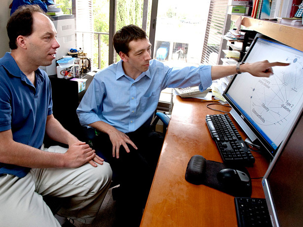 Stephen Quake (left) and Euan Ashley review genetic risk factors that Ashley and colleagues found in Quake's genome.