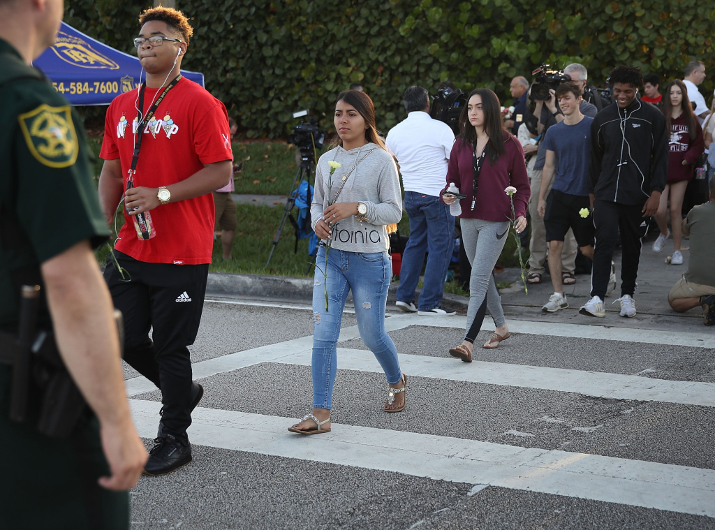 Students Return To Class For First Time After Mass Shooting At Florida School Students cross as they arrive to attend Marjory Stoneman Douglas High School for the first time since the shooting that killed 17 people on February 14 at the school on February 28, 2018 in Parkland, Florida.