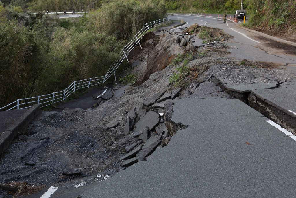 42 Dead And Rescue Work Continues After Japan Earthquake KUMAMOTO, JAPAN - APRIL 17: A road collapse and landslide are seen on April 17, 2016 in Kumamoto, Japan. A magnitude-7.3 earthquake hit Kumamoto prefecture on Japan's Kyushu Island on Saturday after one measuring 6.4 struck on Thursday. As of Sunday, reports indicate that 42 people have been killed, 1,500 were injured, and 11 people remain missing. An estimated 80,000 homes are without power and 400,000 homes have no running water. (Photo by Taro Karibe/Getty Images)
