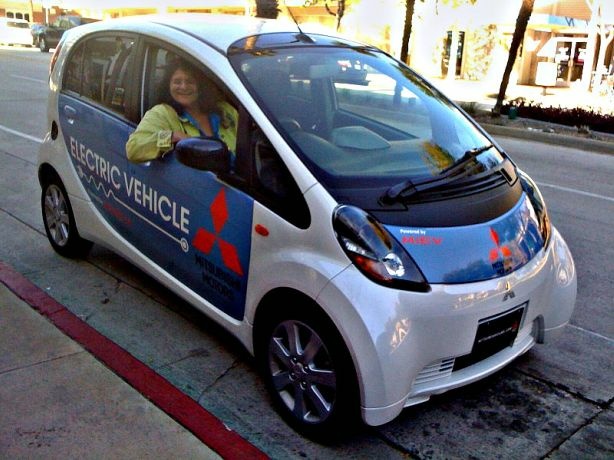 Shirley Jahad in a Mitsubishi electric iMiev prototype with the steering wheel on the right side.