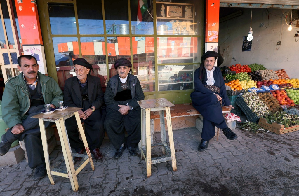 IRAQ-KURDS-ANNIVERSARY-HALABJA Iraqi Kurdish men sit together outside a tea house in the city of Halabja, about 190 miles northeast of Baghdad, on March 16, 2014. In 1988, Iraqi president Saddam Hussein launched a chemical gas attack on the Kurdish town, killing 5,000 people.