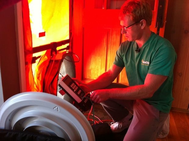 Scott Lowery audits residential energy efficiency for the rooftop-solar financing company. Before they install panels, SolarCity workers check and fix places where energy leaks in a home.