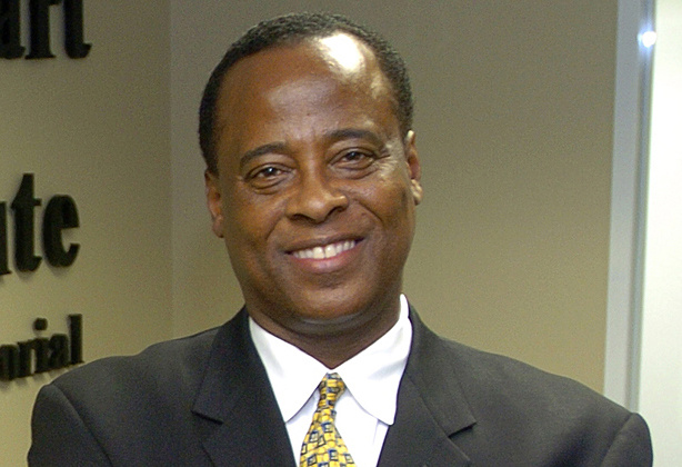 FILE - In this July 7, 2006 file photo, Dr. Conrad Murray poses for a photo as he opens the Acres Homes Cardiovascular Center at the Tidwell Professional Building, in Houston. Murray is the target of a manslaughter investigation into the singer's death. A search warrant filed in a Houston court Thursday July 23, 2009 allowed authorities to seek evidence of whether Dr. Conrad Murray committed manslaughter. The doctor accused of administering a powerful anesthetic that killed pop star Michael Jackson has helped stabilize a young woman who fell unconscious on a US Airways jet to Phoenix.