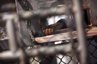 Mercer 17333 A detainee waits for lunch inside the U.S. detention center for 'enemy combatants' in Guantanamo Bay, Cuba.