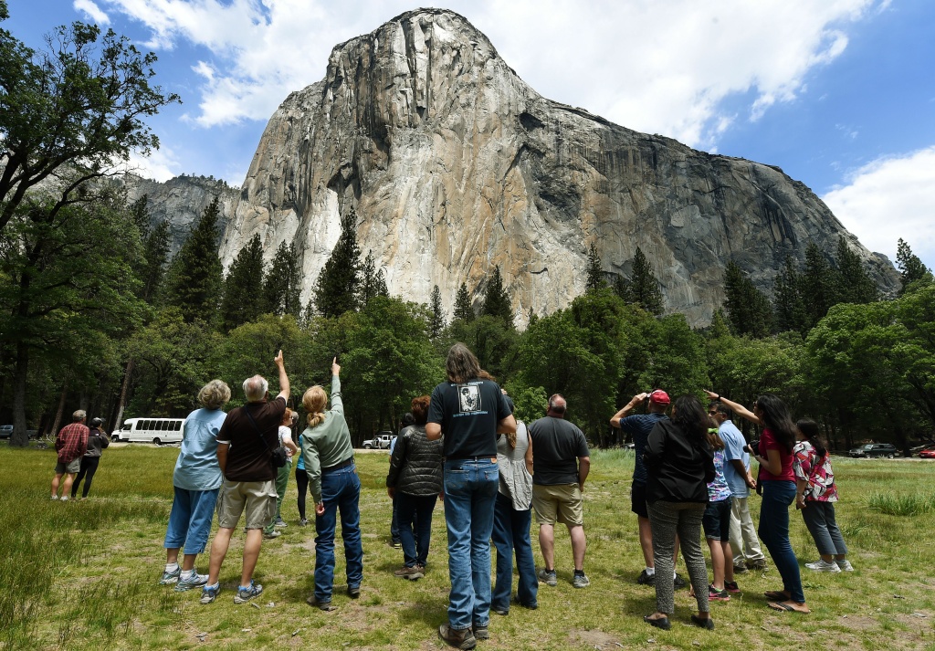 ENVIRONMENT-US-TOURISM-DROUGHT-YOSEMITE Visitors look up at the El Capitan monolith in the Yosemite National Park in California.