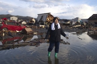 Mercer 15969 Chieko Chiba walks through the rubble after going to see her destroyed home March 16, 2011 in Kesennuma, Miyagi province, Japan.