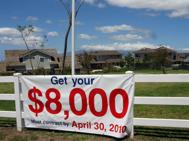 A sign in Maui, Hawaii, urges people to buy before the $8,000 tax credit expires. Both individuals and businesses can get credits.