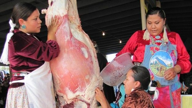 Miss Navajo contestants must work in teams to butcher sheep. From left, Wallitta Begay, Leandra "Abby" Thomas and Charlene Goodluck had to cut the sheep's throat, remove the stomach and quarter the carcass.