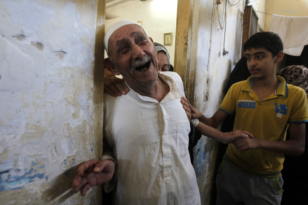 PALESTINIAN-ISRAEL-CONFLICT-GAZA-FUNERAL Relatives and friends of al-Hajj family mourn as they gather in a mosque to pray over the bodies of the eight family members during their funeral in Khan Yunis, in the southern Gaza Strip, on July 10, 2014. Israeli warplanes pounded Gaza relentlessly, causing a growing number of civilian casualties, as the UN Security Council was to meet urgently over Israel's spiralling confrontation with Hamas.