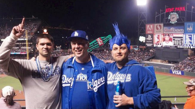 Photo of Jonathan Denver (pictured left) with his father (center) and brother at a Dodgers-Giants game in San Francisco, hours before Denver was fatally stabbed in an argument near the stadium.