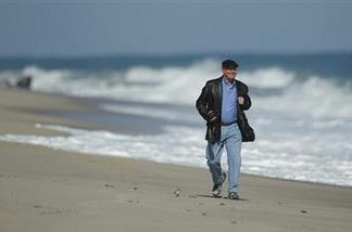 Michael Vanatta walks the beach near where he takes a photo each day of the sun rise in Vero Beach, Fla. for one of his blogs. Vanatta, 61, is paying the price for being a baby boomer who enjoyed life without saving for the future. He put a daughter through college, but he also spent plenty of money on indulgences like dining out and the latest electronic gadgets. Vanatta was laid off last January from his $100,000-a-year job as a sales executive for a turf company. And with savings of just $5,000, he's on a budget for the first time. In April, he will start taking Social Security at age 62.