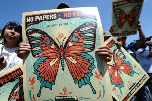 Demonstrators hold signs supporting undocumented immigrants during a rally in Charlotte, NC ahead of the Democratic National Convention, Sept. 2, 2012