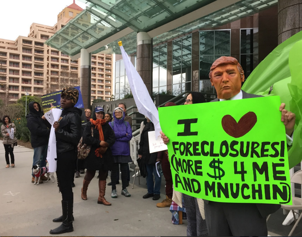 Community activists protest the nomination of Steven Mnuchin as Treasury Secretary outside the Goldman Sachs offices in Century City, and later, Mnuchin's Bel Air home.