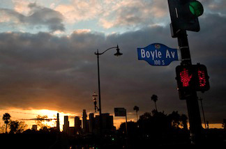 Looking out from near Mariachi Plaza, the sun sets over downtown Los Angeles on the evening of Sunday, March 27, 2011.