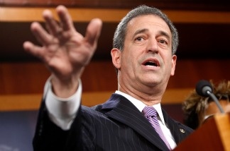 U.S. Sen. Russell Feingold (D-WI), shown here during a news conference on Capitol Hill in 2009, is locked in a close race for re-election against Republican Ron Johnson. Both have campaign ads spinning their stance on the new health care law.