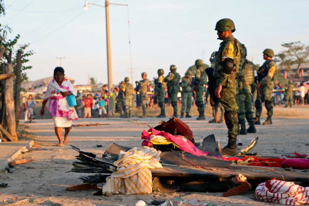 MEXICO-QUAKE A soldier observes the remains of a military helicopter that fell on a van in Santiago Jamiltepec, Oaxaca, Mexico, on February 17, 2018.