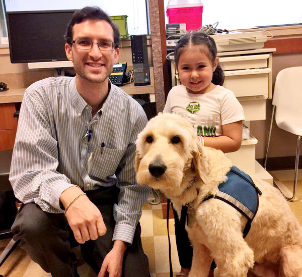 Dr. Evan Los with one of his patients, Sophia, and her diabetes dog St. Nick. Dr. Evan Los with one of his patients, Sophia, and her diabetes dog St. Nick.