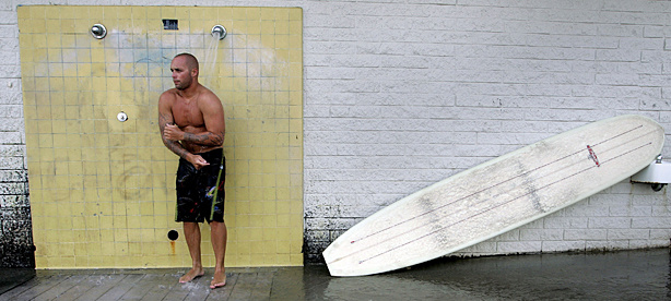 Surfer Tony Gamboa showers off the salt water after he finshed his day of surfing at Surfrider Beach August 4, 2005 in Malibu, California. An envriomental group has named Malibu's Surfrider Beach as the dirtiest beach in Los Angeles County.