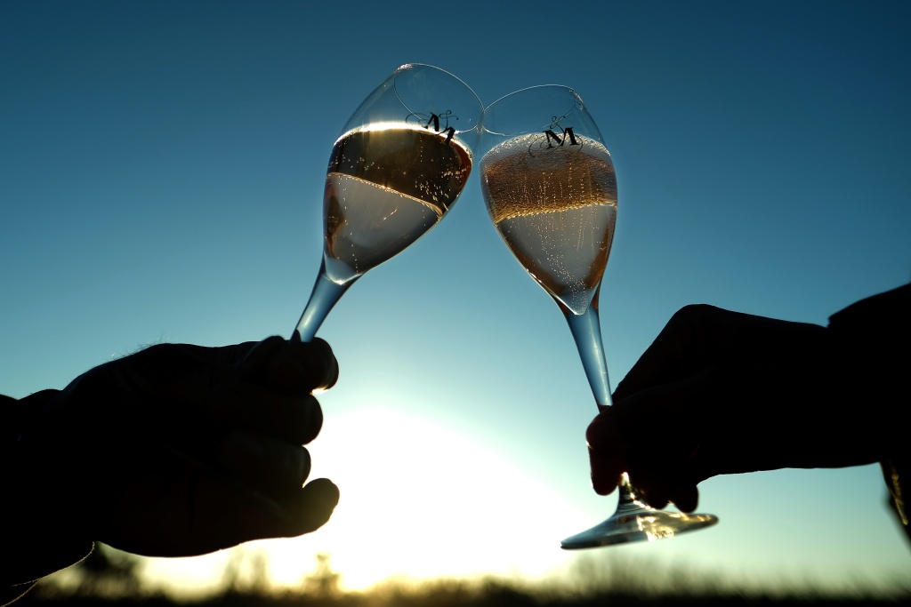 FRANCE-WINE-LABEL People hold glasses of rose wine on January 3, 2017 in Cabrieres d'Aigues, France.