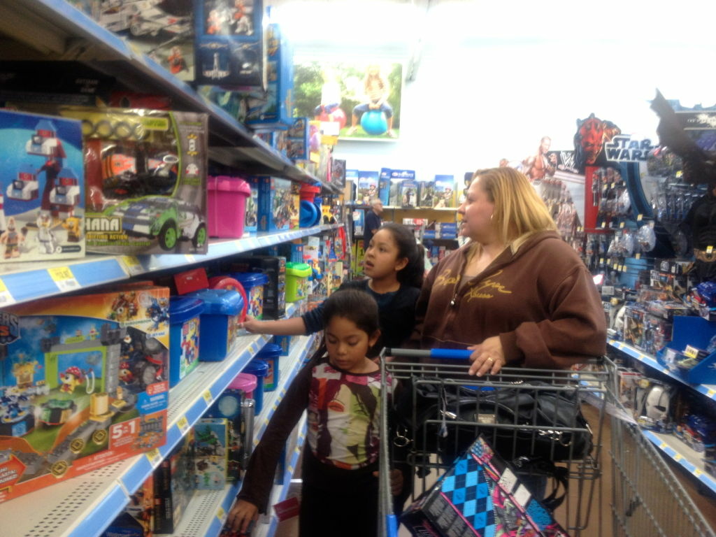 Last minute shoppers Hailey Mendoza, 7, and Jocelyn Mendoza, 9, shop with their mom Sandra Mejia at the Walmart in Rosemead. Mejia looking for gifts on Dec. 20, just five days before Christmas.