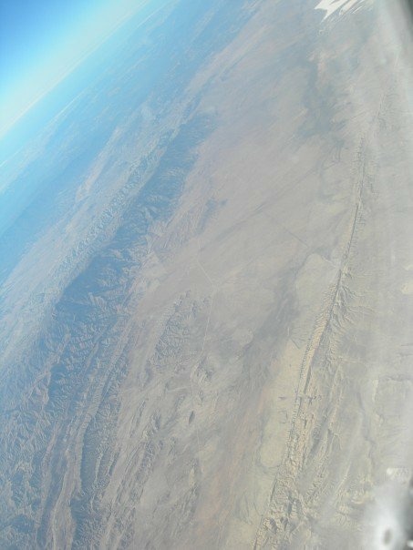 The San Andreas Fault looks like a scar (on the bottom) in the Carrizo Plain area. This image was taken from the air in 2007.