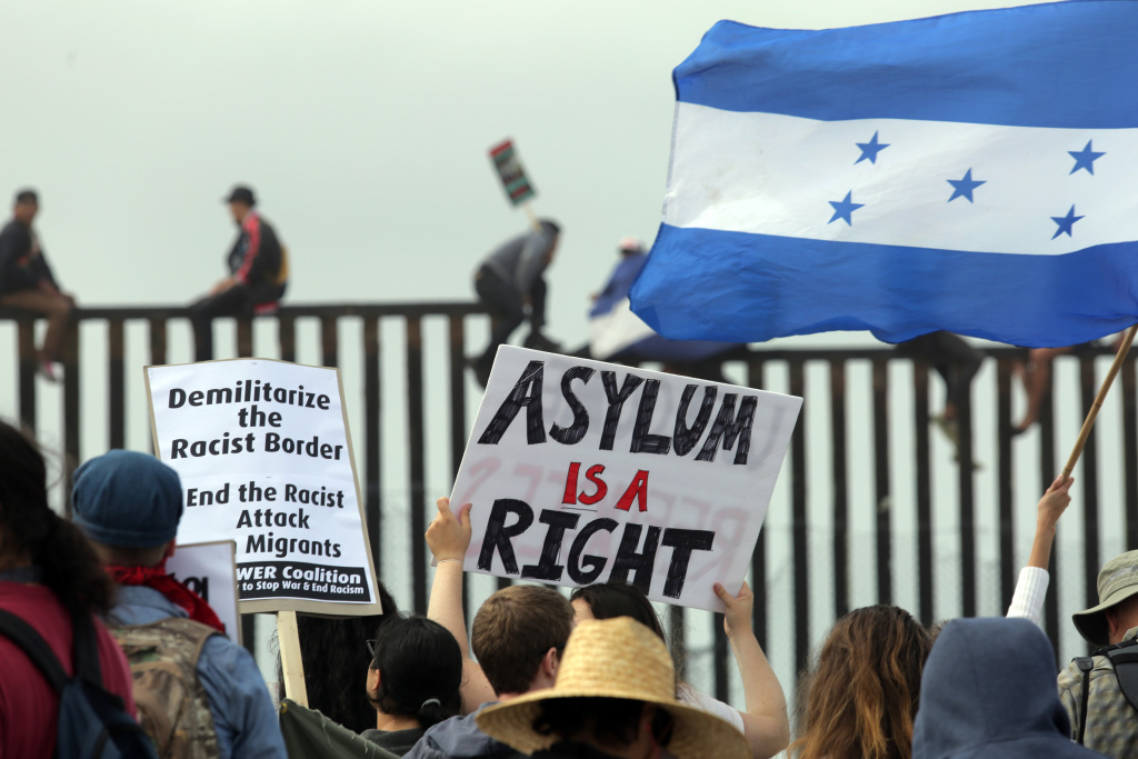 Supporters And Detractors Of Trump's Immigration Policies Demonstrate On Mexican Border Pro-migrant caravan demonstrators, including a woman waving a Nicaraguan flag, rally at the west end of the U.S.-Mexico border as others climb the border wall from the Mexican side on April 29, 2018 in San Diego, California.