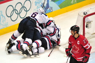 US players celebrate next to Canada's defender Scott Niedermayer at the end of the Men's preliminary Ice Hockey match Canada against USA at the XXI Winter Olympic games in Vancouver's Canada Hockey Place on February 21, 2010. USA won 5-3.