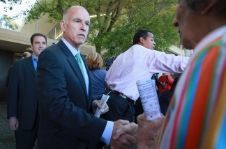 California attorney general and democratic gubernatorial candidate Jerry Brown (2nd L) greets a voter after voting on November 2, 2010 in Oakland, California. Jerry Brown is in a tight race to win the election for California governor against republican challenger and former eBay CEO Meg Whitman.