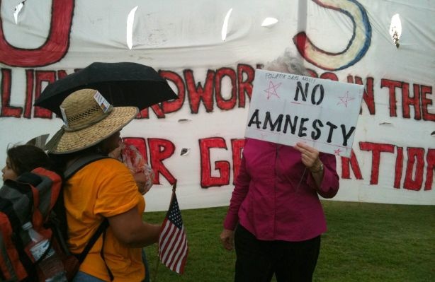 A supporter of SB 1070 engages in a conversation with Gloria Godoy, a Guatemalan American who came from Los Angeles to protest against Arizona's new immigration law.