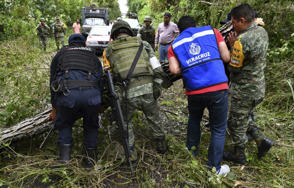 MEXICO-HURRICANE-KATIA Mexican army soldiers and policemen remove fallen trees blocking a road after the passage of Hurricane Katia in Boca de Lima, Veracruz state, Mexico on September 9, 2017.
Storm Katia made landfall as a Category One hurricane and hours later was downgraded to a tropical storm with maximum sustained winds of 45 miles (70 kilometers) per hour. / AFP PHOTO / YURI CORTEZ (Photo credit should read YURI CORTEZ/AFP/Getty Images)