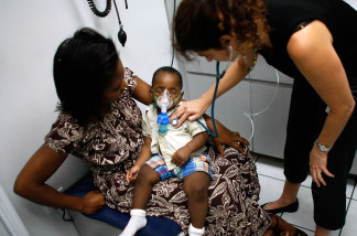 File photo: Pediatrician, Dr. Gwen Wurm, does a checkup on D'Acquel Emmanuel Sema, 13-moths-old, as he is held by his mother, Adelaide Sema at the University of Miami Pediatric clinic October 3, 2007 in Miami, Florida.