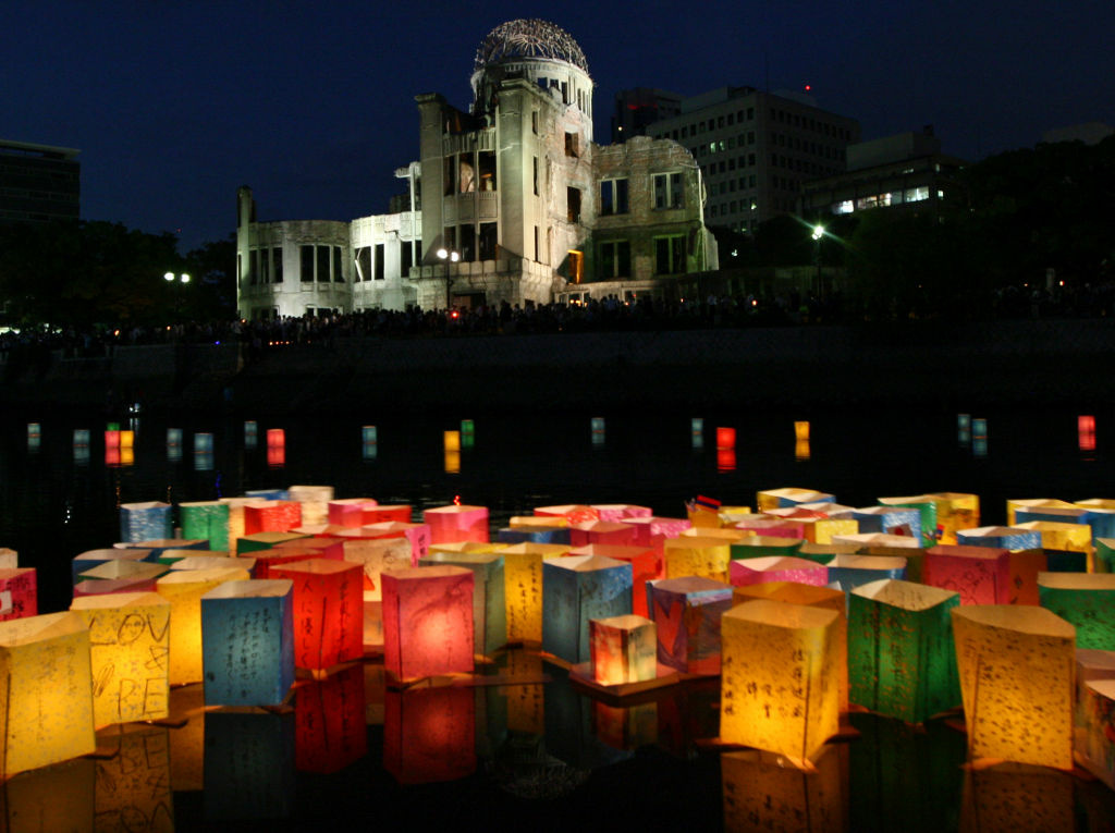 Japan Marks 67th Anniversary Of Hiroshima Atomic Bomb HIROSHIMA, JAPAN - AUGUST 06: Paper lanterns float on the Motoyasu River in front of the Hiroshima Peace Memorial, commonly called the Atomic Bomb Dome, at the Hiroshima Peace Memorial Park on August 6, 2012 in Hiroshima. Japan. Japan is marking the 67th anniversary of the first atomic bomb dropped on Hiroshima by the United States on August 6, 1945, which killed an estimated 70,000 people instantly and many thousands more over the following years from radiation. Three days later another atomic bomb was dropped on Nagasaki, that effectively ended World War II. (Photo by Buddhika Weerasinghe/Getty Images)